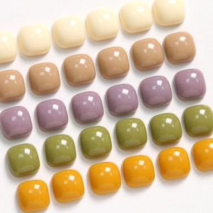 Close-up of colorful 10mm square resin charms with glossy finish for DIY jewelry crafts