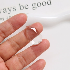 Macro shot showing faceted clear resin geometric ring with light refraction details