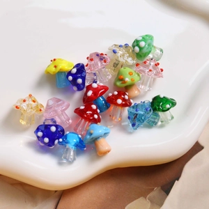 Close-up of colorful polka dot mushroom glass beads for DIY jewelry making accessories