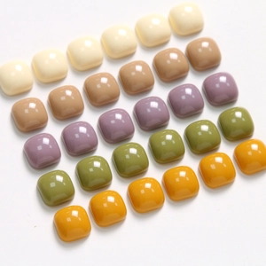Detailed view of colorful 10mm square resin charms with a glossy finish for DIY jewelry