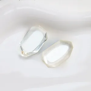 Macro shot of two octagonal faceted transparent resin stones for DIY jewelry making