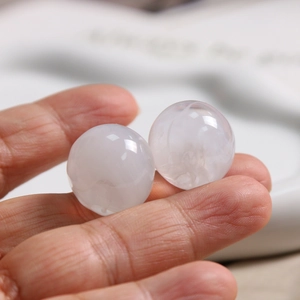 Macro shot of 20mm round translucent white resin beads with smooth ink-dyed texture