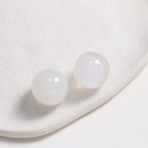 Macro shot of 20mm round white ink-style resin cabochons with smooth matte finish for DIY