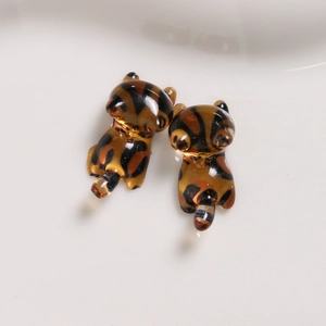 Macro view of leopard print resin kitten charms for DIY jewelry and phone cases