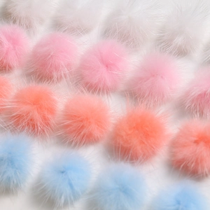 Macro shot of 3cm colorful fluffy faux fur pom poms for DIY crafts and clothing accessories