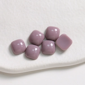 Macro shot of 10mm purple square resin tiles with rounded corners for DIY jewelry making