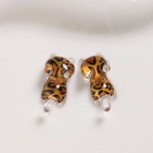 Detail of handmade amber leopard print glass cat charms for DIY jewelry making