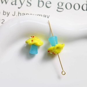 Macro shot of yellow and blue mushroom glass beads with colorful dots for DIY jewelry