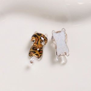 Close-up of resin mini leopard print and blue running cats for DIY phone case accessories
