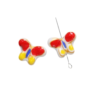 Perle papillon en céramique peinte à la main avec motifs rouges et bordures dorées