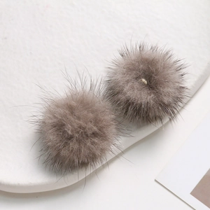 Macro shot of 3.5cm grey-brown mink fur poms for DIY jewelry and hair accessories