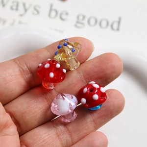 Close-up of handmade colorful polka dot glass mushroom beads for DIY jewelry making