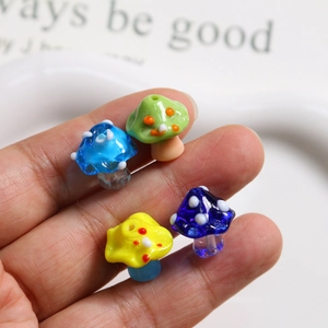 Close-up of colorful handmade polka dot glass mushroom beads for DIY jewelry making