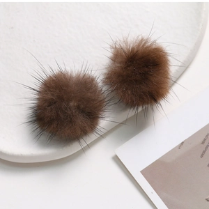 Close-up of soft brown mink fur balls for DIY hair accessories and jewelry making