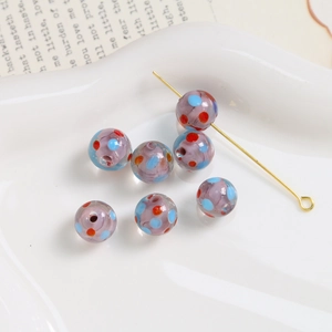 Macro shot of 10mm lavender glass beads with colorful dots for DIY jewelry making