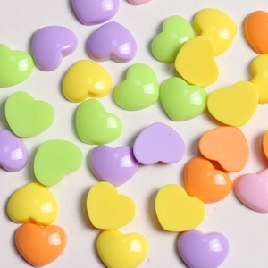 Colorful glossy acrylic heart charms in purple, yellow, and green for DIY accessories