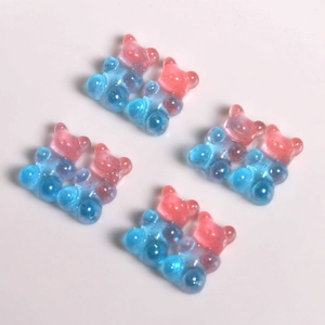 Close-up of dual-tone pink and blue gradient resin bears with glitter for DIY crafts