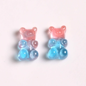 Detail of gradient pink and blue resin bears with glitter for DIY jewelry crafts