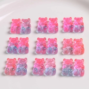Close-up of pink and blue gradient glitter resin bear charms for DIY accessories