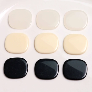 Polished square resin jewelry parts in cream, white and black colors displayed in 3x3 grid