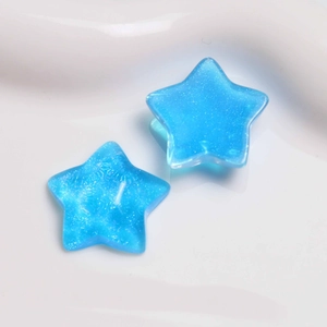 Detail of blue glitter resin star charms for DIY earrings and hair accessories craft