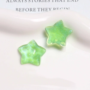 Close-up of glittery lime green resin star charms for DIY earring and hair jewelry making