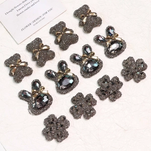 Macro detail of sparkly bear, rabbit, and clover resin charms for DIY jewelry making