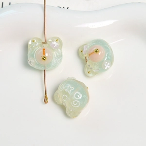 Vista macro de dijes de oso de resina con purpurina verde menta para joyería DIY