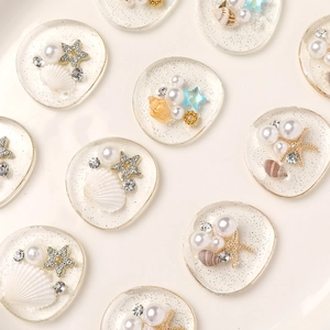 Ocean style resin shoe charms with pearls and starfish in a flat lay arrangement
