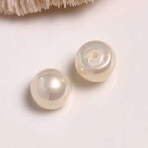 Macro view of creamy white round pearl beads for DIY jewelry and earring crafts