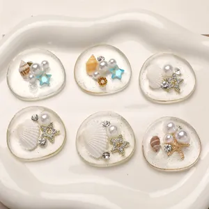 Detailed view of DIY ocean resin charms with pearls, shells, and starfish for crafts