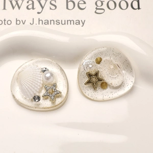Macro detail of summer resin charms with shells and pearls for DIY accessories
