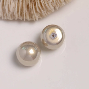 Detailed macro view of champagne pearl beads with axial holes for jewelry DIY