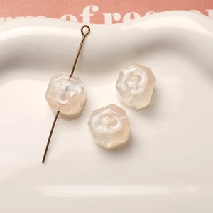 Vista de cuentas de resina octogonales con purpurina y motivos de luna y estrellas DIY