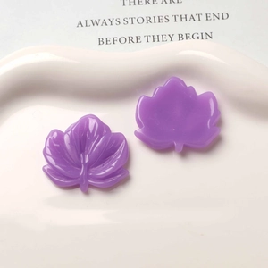 Detail of purple resin maple leaf charms showing leaf vein texture and flat back surface