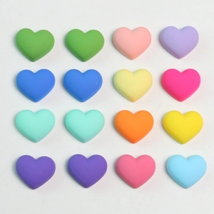 Flat lay of colorful matte heart-shaped acrylic beads in 4x4 grid for DIY jewelry making