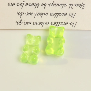 Macro shot of two light green translucent resin bear charms for DIY accessories