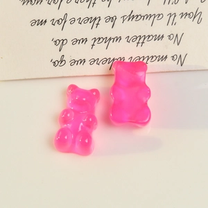 Detailed view of two rose pink gummy bear resin charms for DIY earring and phone case
