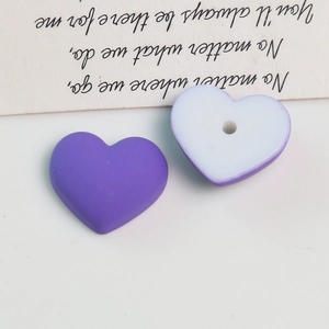 Macro shot of purple macaron acrylic heart beads and DIY earring jewelry components