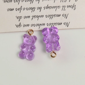 Detailed view of purple resin gummy bear charms with golden loops for DIY jewelry making