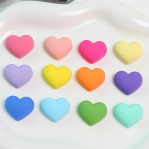 Detailed macro view of 12 colorful matte macaron heart-shaped acrylic DIY craft accessories