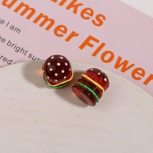 Macro view of handmade 3D resin hamburger charms for DIY earring and hair accessories