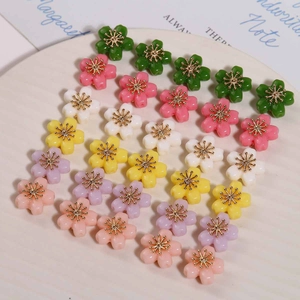 Macro view of colorful five-petal alloy flower beads with golden metal stamens