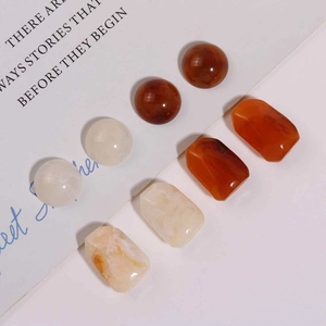 Detailed shot of amber and marble-textured resin beads for DIY earring and jewelry making
