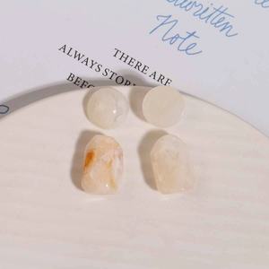 Flat lay of retro irregular resin beads and marble texture earrings on white tray