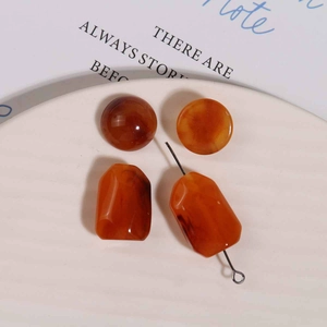 Macro detail of amber resin beads with vintage swirl patterns for DIY jewelry making