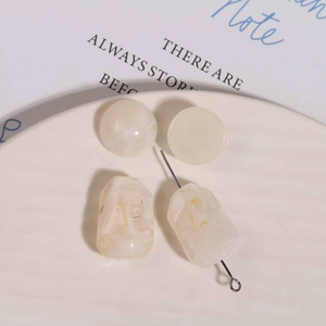Macro view of vintage irregular resin beads with marble texture for DIY earring making
