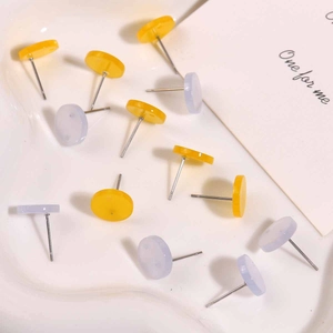 Flat round jelly acrylic earrings set in yellow and light blue colors on white tray