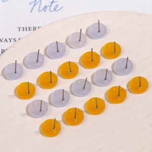 Flat round acrylic stud earrings in sweet yellow and grey tones with metal pins