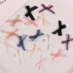 Macro shot of assorted colorful handmade lace organza bow accessories for DIY nail art